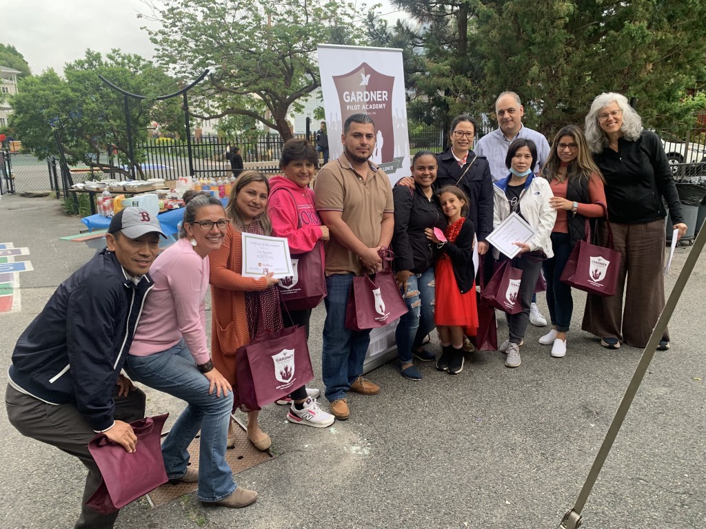 The high intermediate students are pictured with their teacher and volunteers at the end of the year celebration.