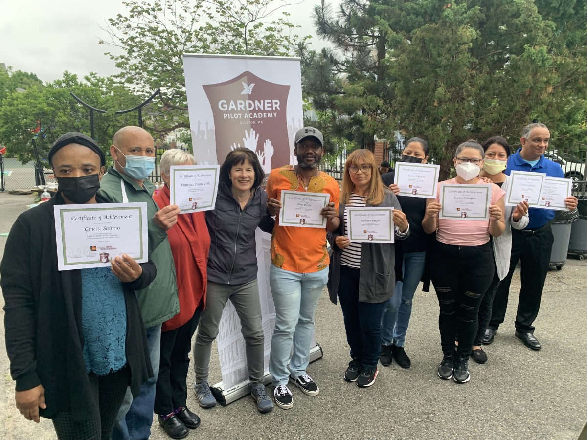 The low intermediate students are pictured with their teacher and volunteers at the end of the year celebration.